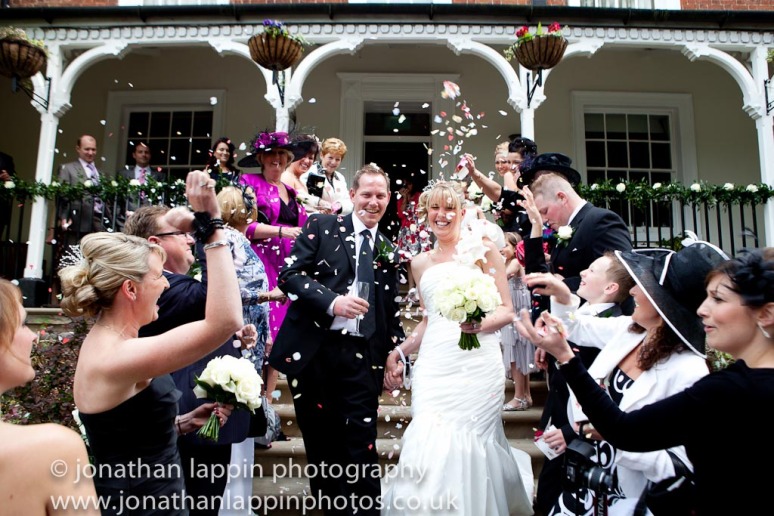 Bride and Groom throwing confetti at Brandshatch Place Hotel n kent wedding photography by Jonathan Lappin 