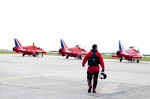 Red 9 walks towards the Red Arrow Jets on the flight line